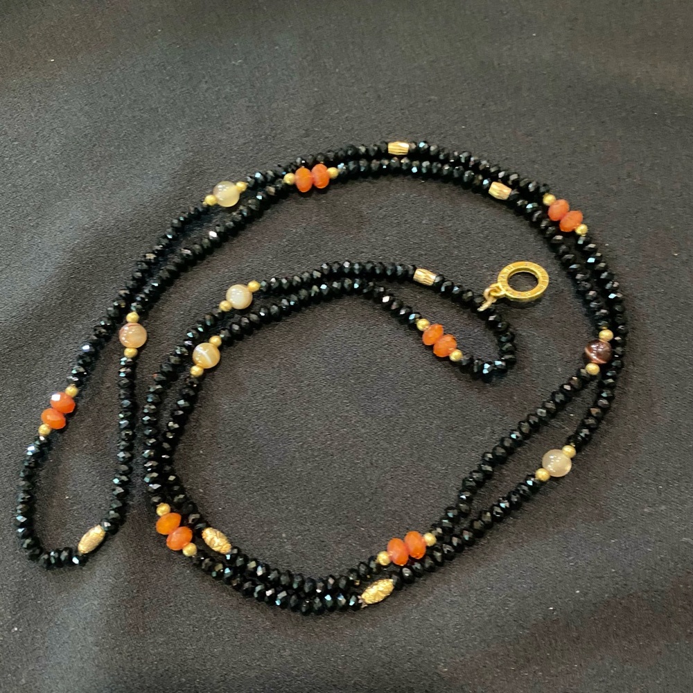 Very reflective gorgeous black necklace with semi precious stones.